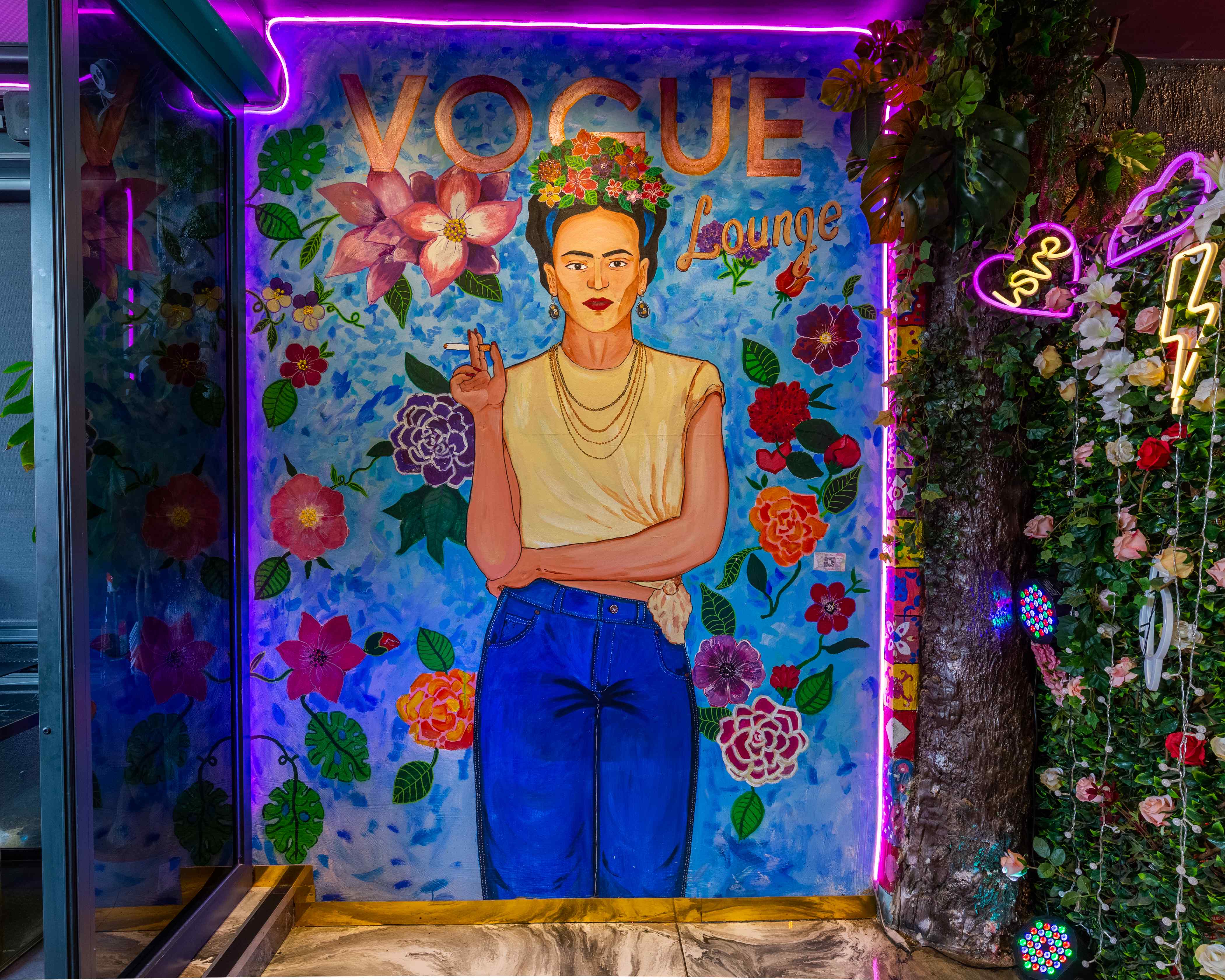 Vogue Lounge mural with vibrant flowers, ideal for creative events and gatherings. - Banner
