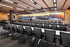 Modern conference room at Bryant Forum with skyline view, ideal for meetings and workshops.