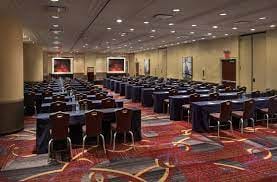 Conference room at Marriott Marquis with rows of tables for corporate meetings and seminars.