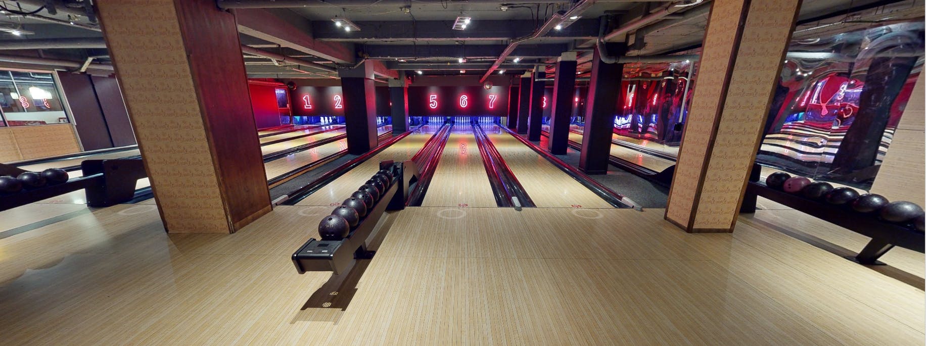 Modern bowling alley with vibrant lighting, ideal for corporate events and team-building.