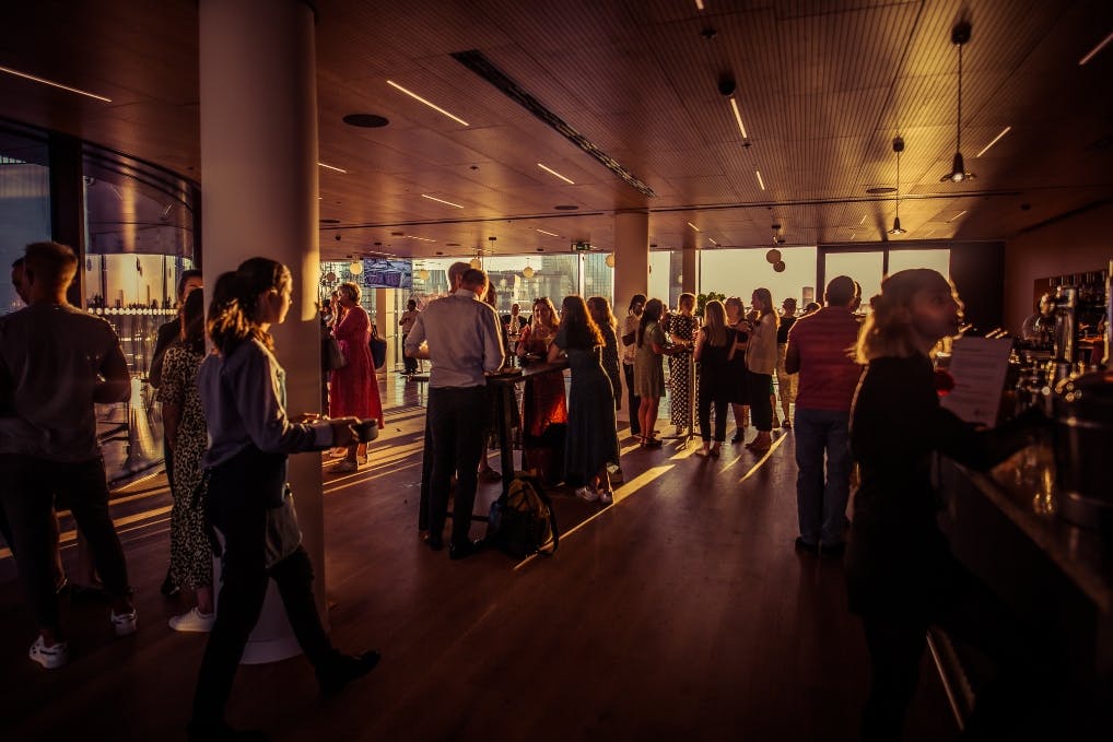 Vibrant networking event at The Circle, Rose Court with warm lighting and social interactions.