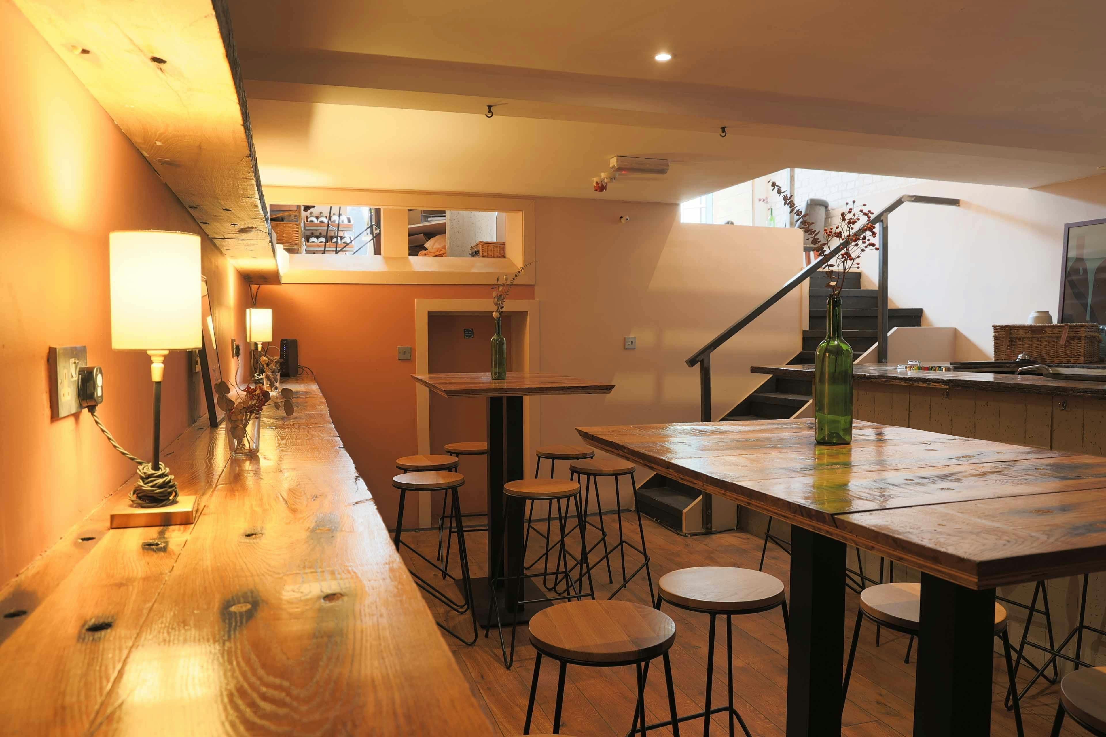 Stylish event space with wooden bar, ideal for intimate gatherings and meetings.