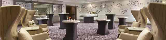 Sophisticated event space with cocktail tables and stylish bar in Hyatt Place Montreal.