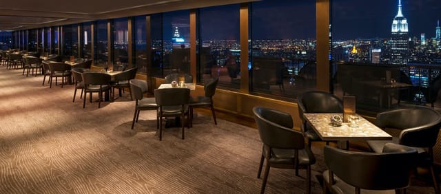 Rainbow Room dining space with elegant tables, perfect for upscale events and gatherings.