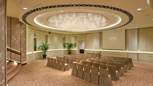 Elegant Ballroom 3 at Fullerton Hotel with plush seating and luxurious chandelier for events.