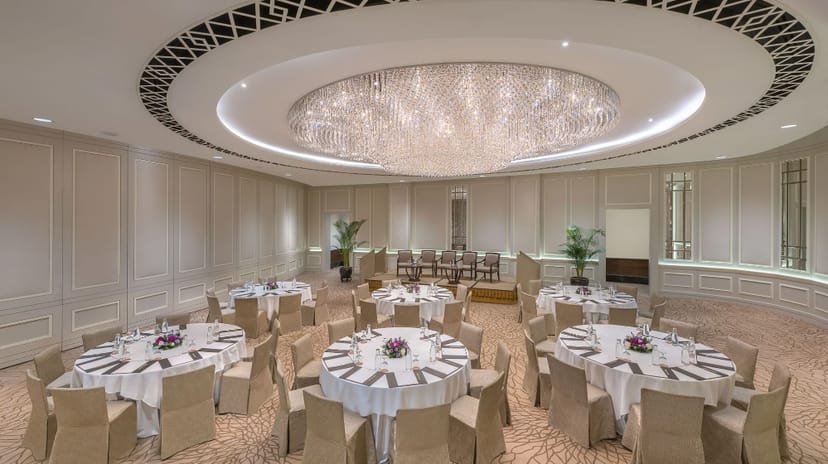 Elegant ballroom with chandelier, perfect for corporate events and social gatherings.