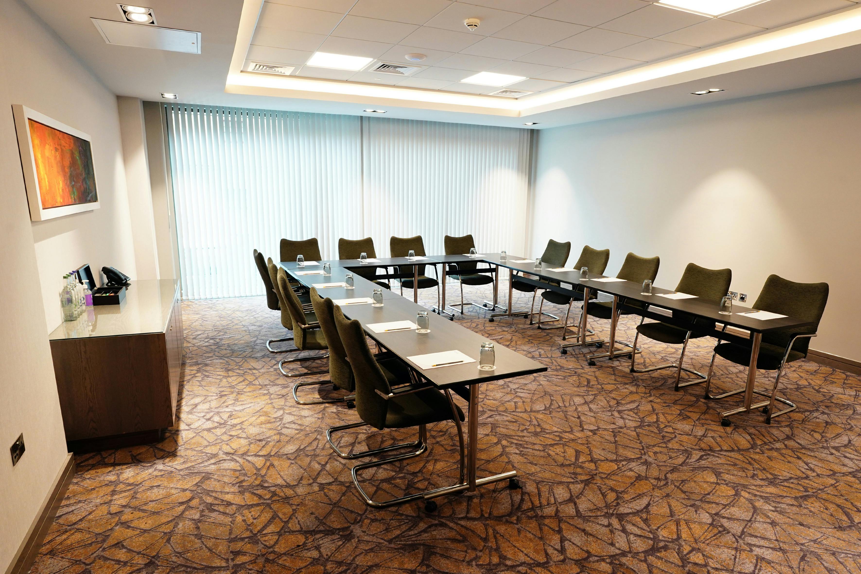 Meeting room at Maldron Hotel Glasgow with long table, ideal for corporate events.