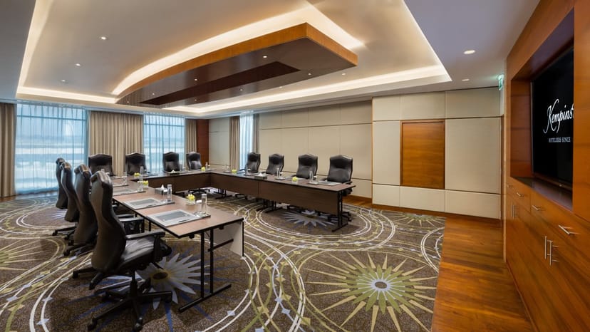 Modern boardroom with large table, ideal for corporate meetings and events.