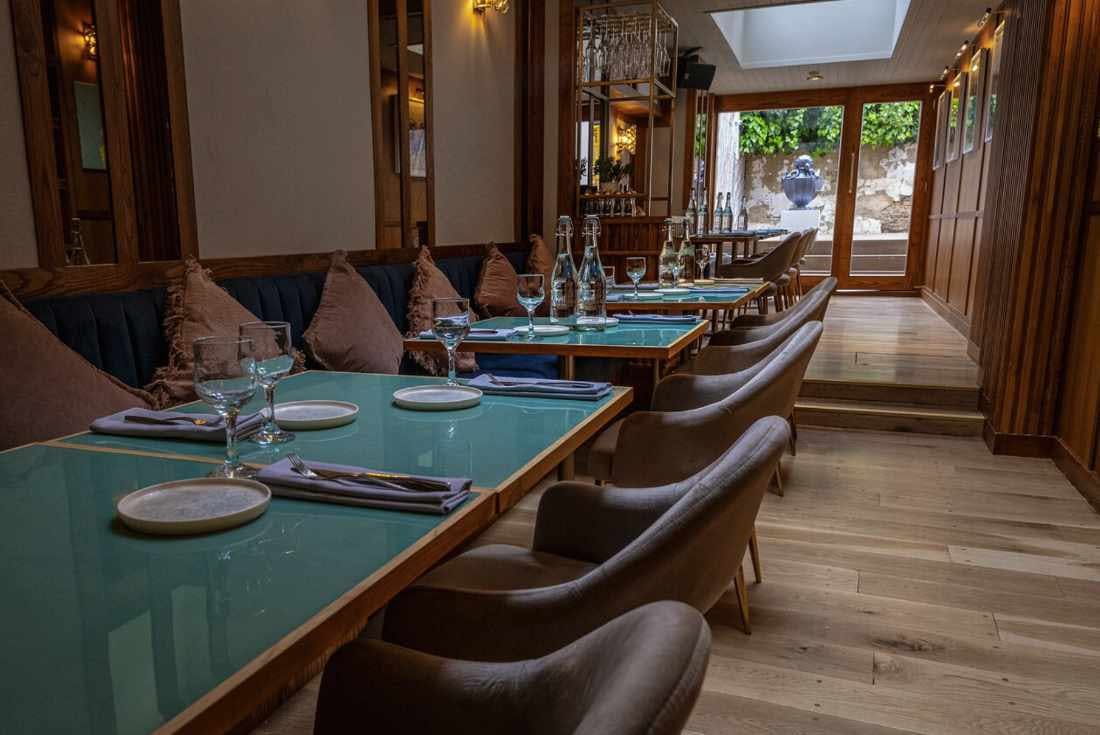 Stylish restaurant setup with elegant tables for intimate corporate events.
