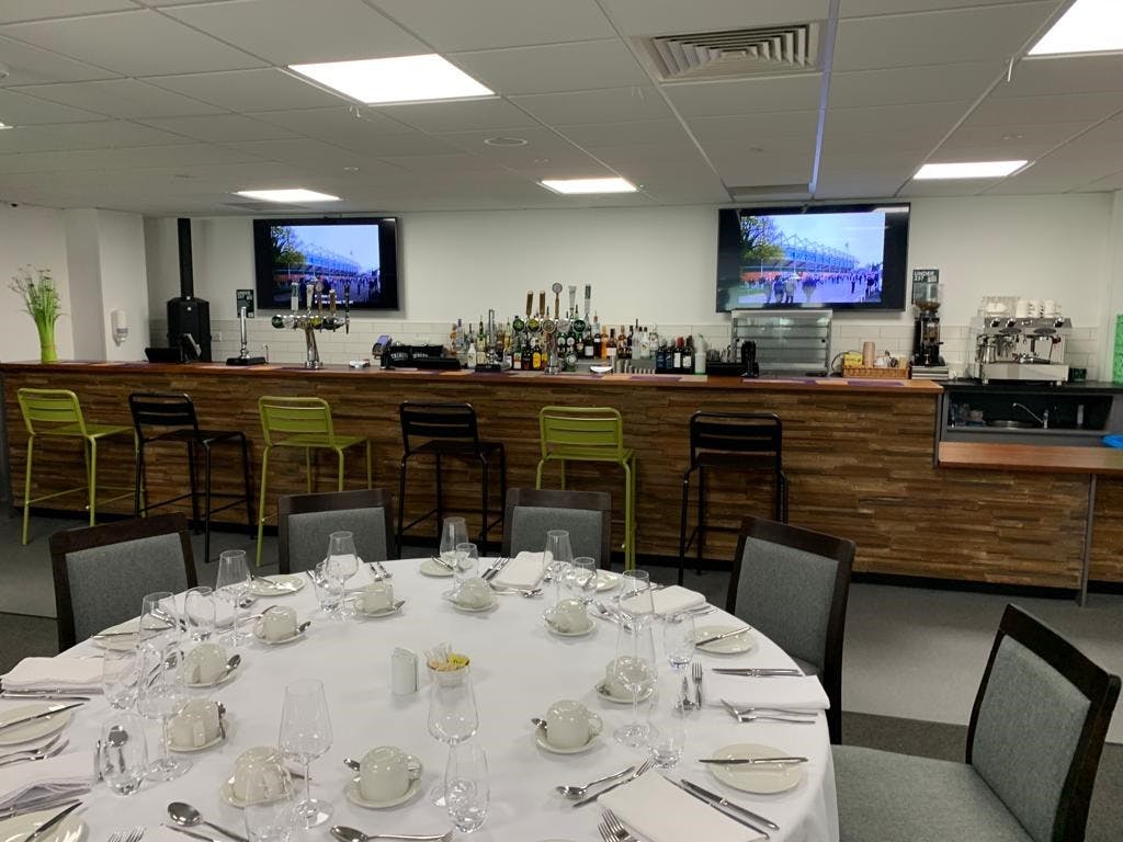 Players' Lounge at Home Park Stadium: modern event space with bar, ideal for gatherings and meetings.