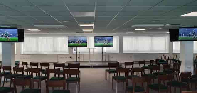 Club Argyle Lounge at Home Park Stadium, set for corporate meetings with large screens.