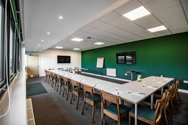 Captain's Lounge at Home Park Stadium, ideal for corporate events with dual screens.