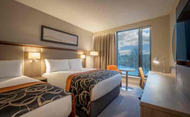 Custom House hotel room with two beds, ideal for business events and conferences.