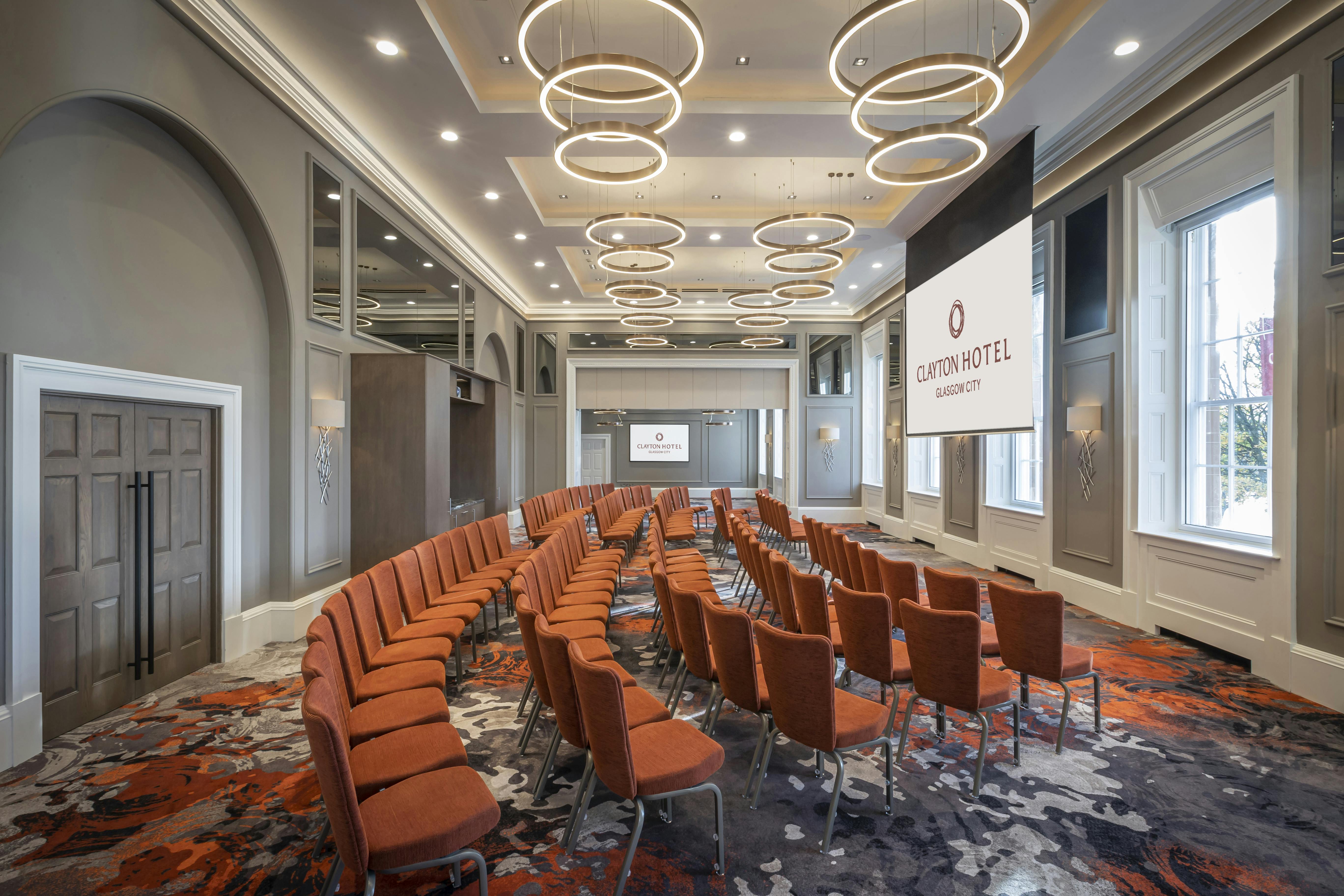Custom House meeting space in Clayton Hotel Glasgow, featuring modern seating for conferences.