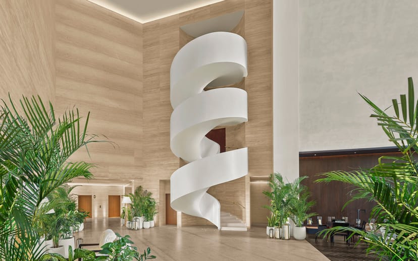 Modern lobby with spiral staircase at Studios Combined, Dubai EDITION for events and networking.