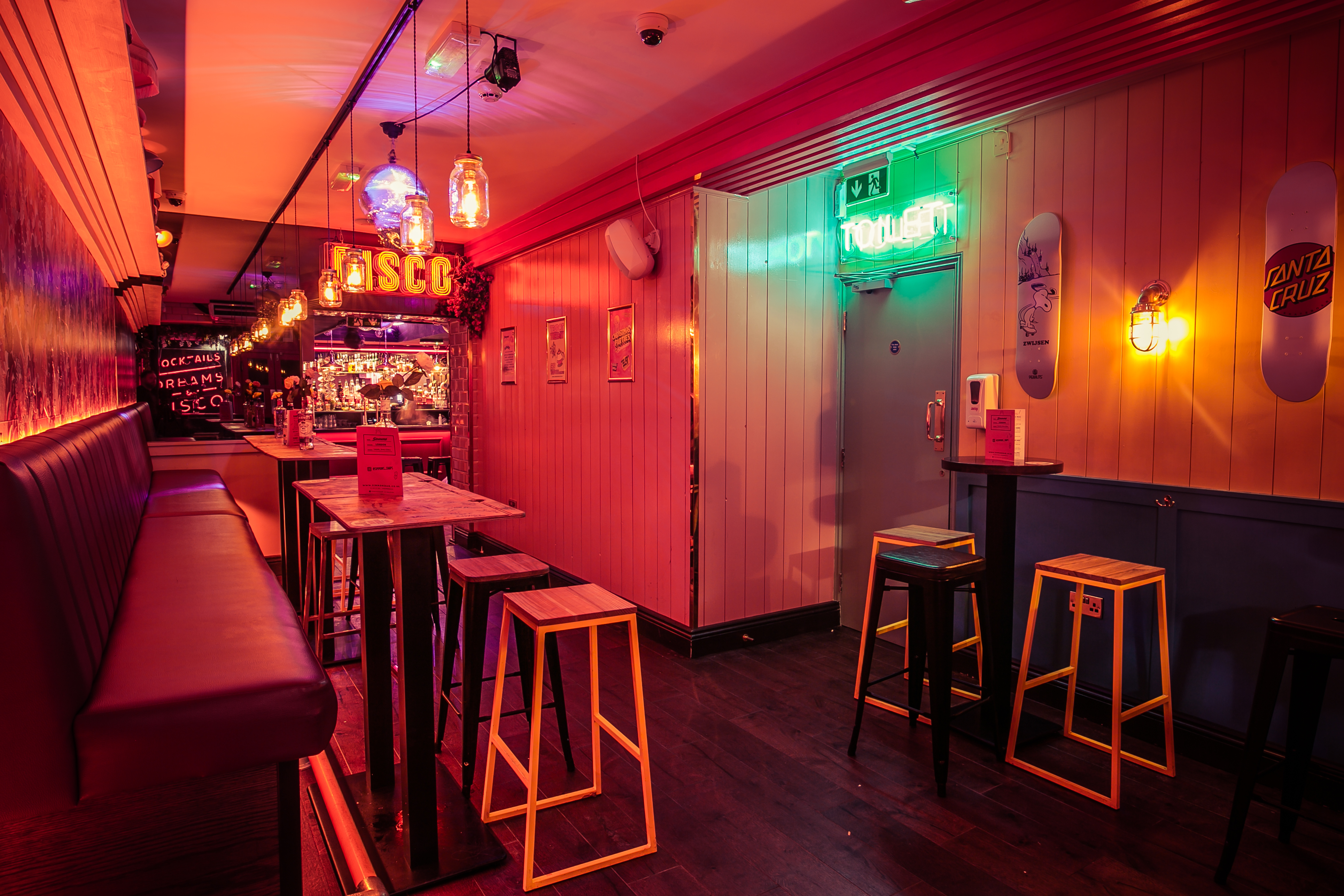 Vibrant event space with neon lighting for gatherings and networking in Tottenham Court Road.