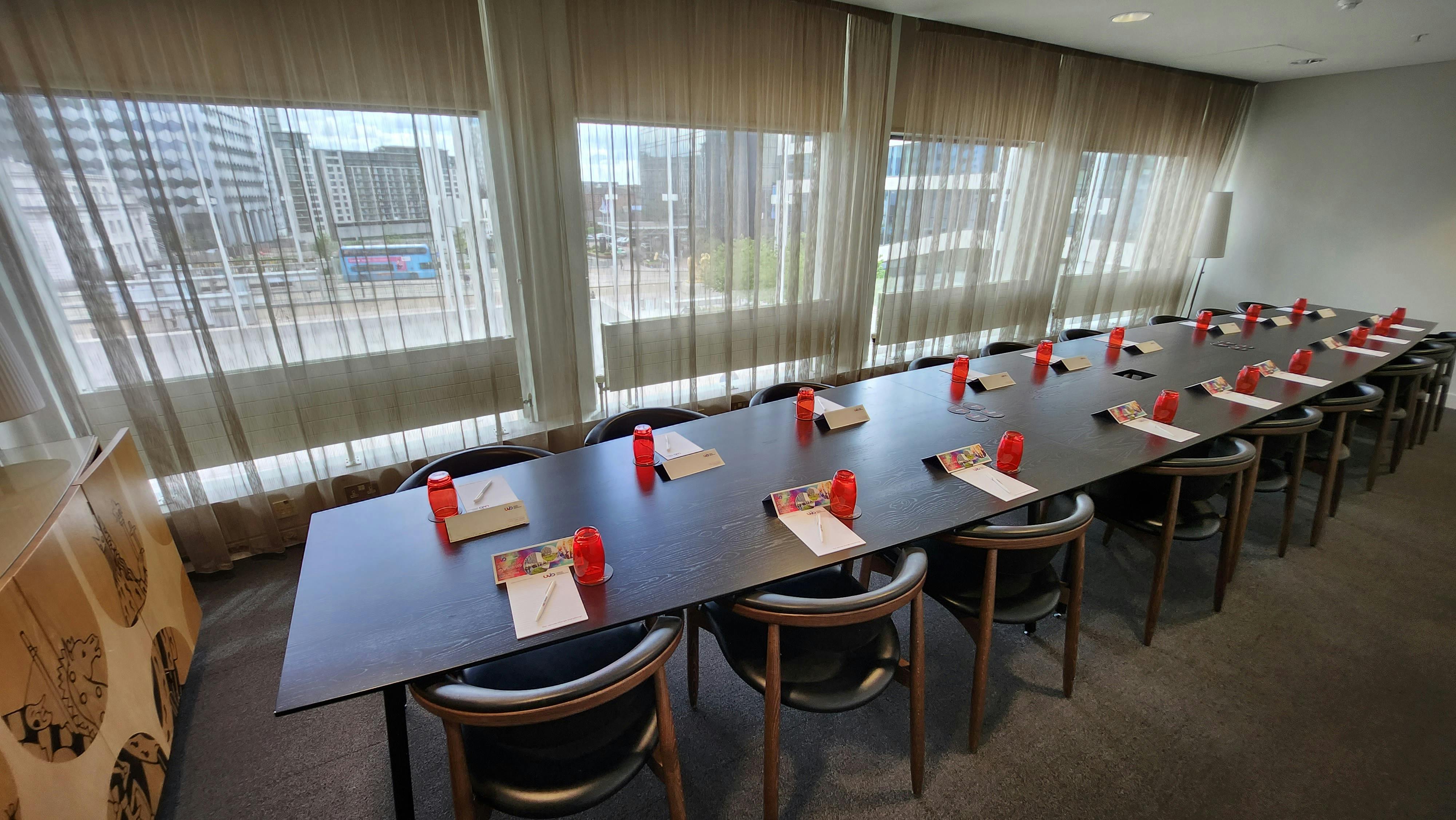 Meeting room at Unique Venues Birmingham with red accents for professional events.