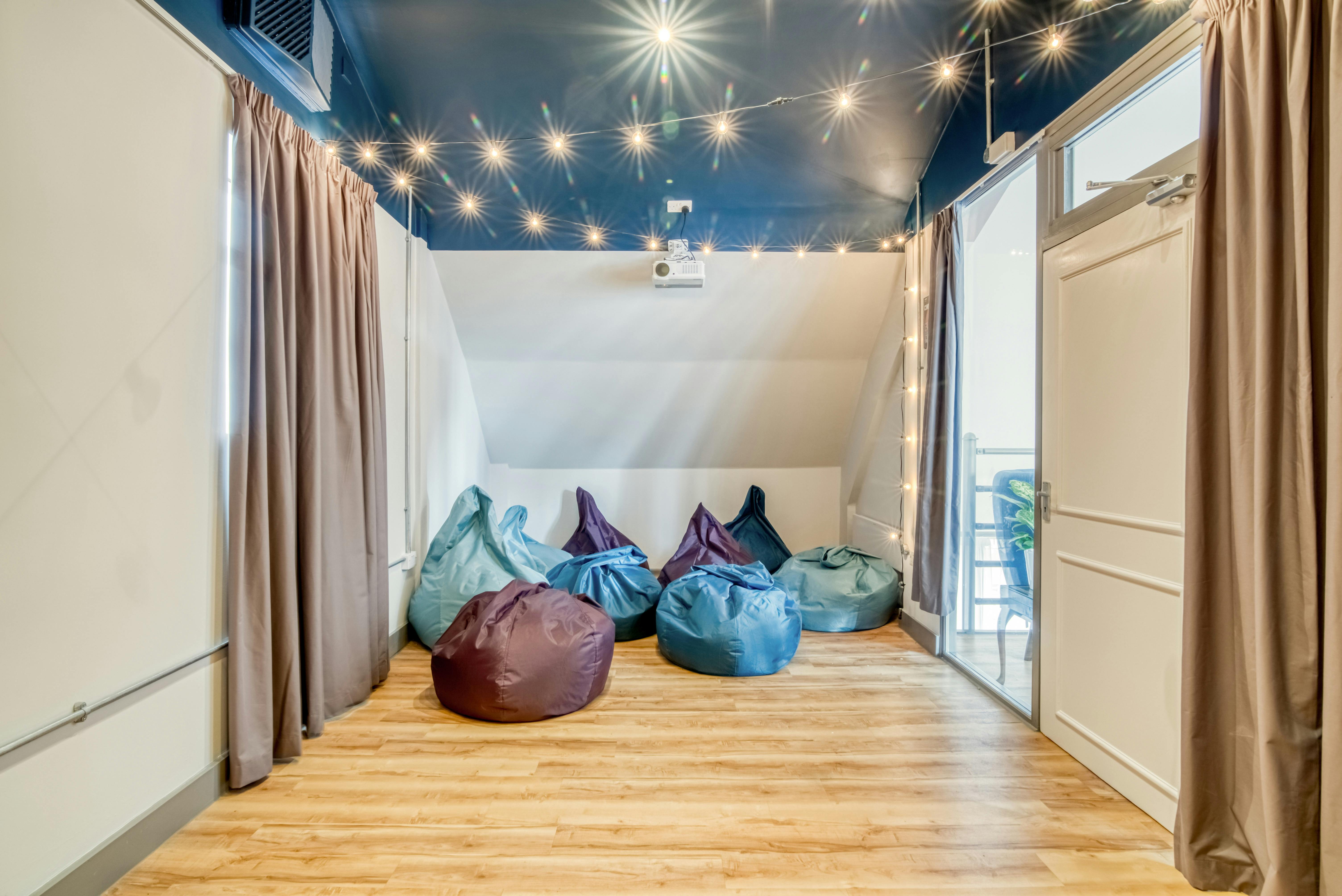 Cozy cinema room with colorful bean bags for creative meetings in Birmingham Selina.