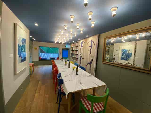 Private dining room at Sam's Cafe with colorful chairs, ideal for meetings and gatherings.