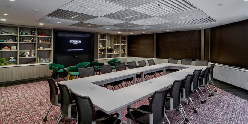 Modern meeting room at Convene, featuring a large table for collaboration and presentations.