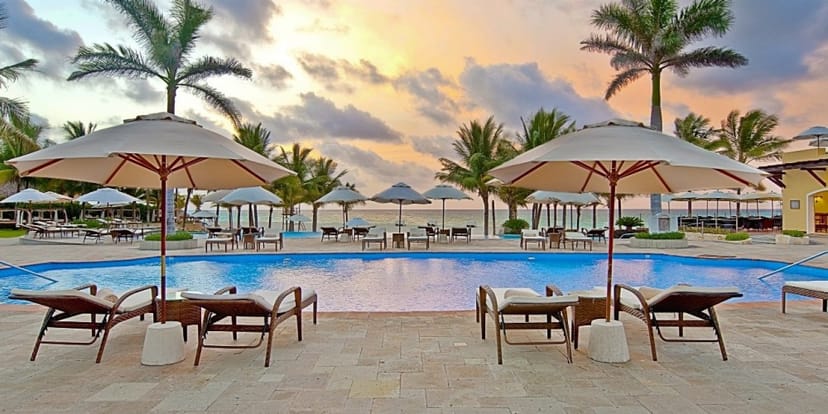 Outdoor event venue with poolside lounge chairs at Royal Hideaway Playacar.