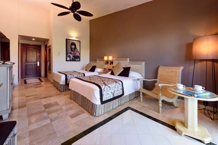 Elegant hotel room with twin beds at Grand Palladium Kantenah Resort for events.