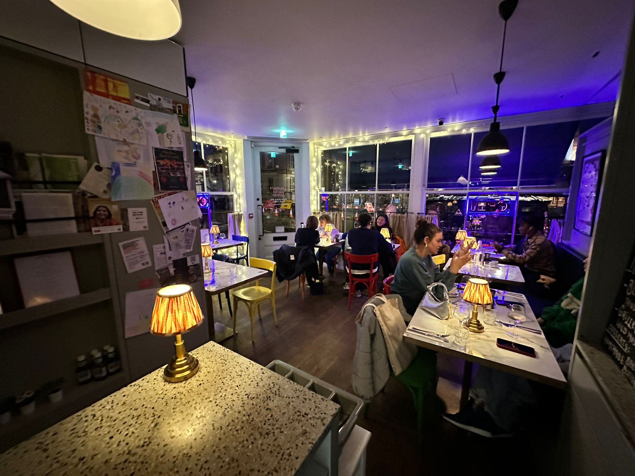 Cozy Sam's Cafe venue with warm lighting, perfect for intimate gatherings and networking events. - Banner