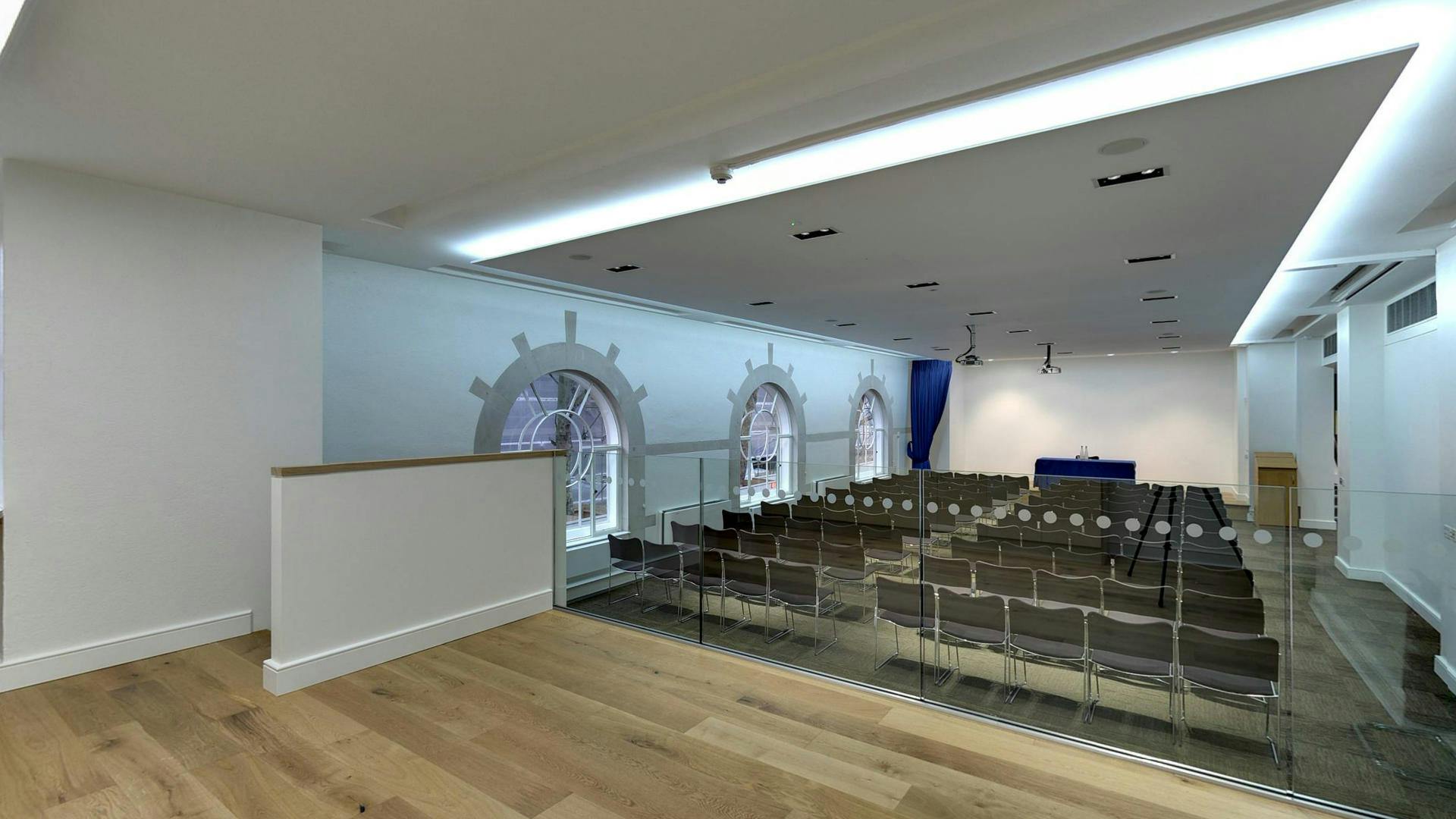 Modern event space with tiered seating and natural light for presentations and meetings.