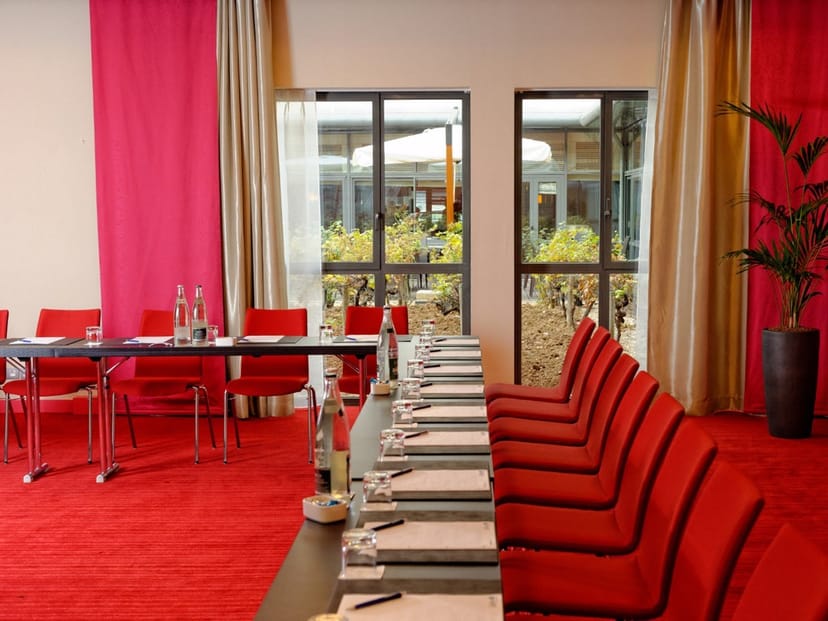 Merlot and Syrah meeting space at Radisson Blu, Paris: vibrant red chairs, natural light.