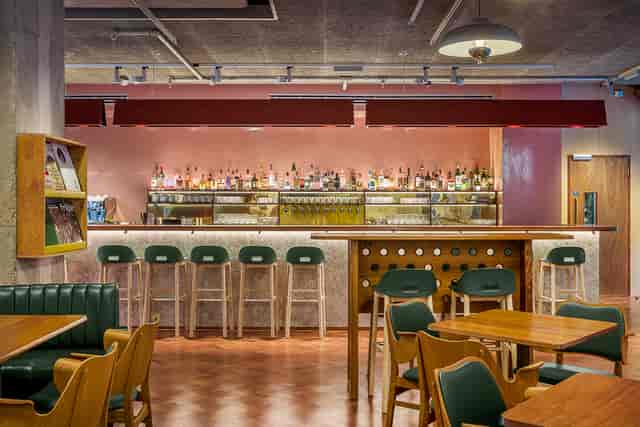 Stylish bar area at Toklas Restaurant, ideal for networking events and casual meetings.