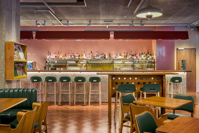 Stylish bar area at Toklas Restaurant, ideal for networking events and casual meetings.