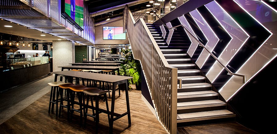 Modern event space in Tottenham Hotspur Stadium with stylish staircase, ideal for meetings.