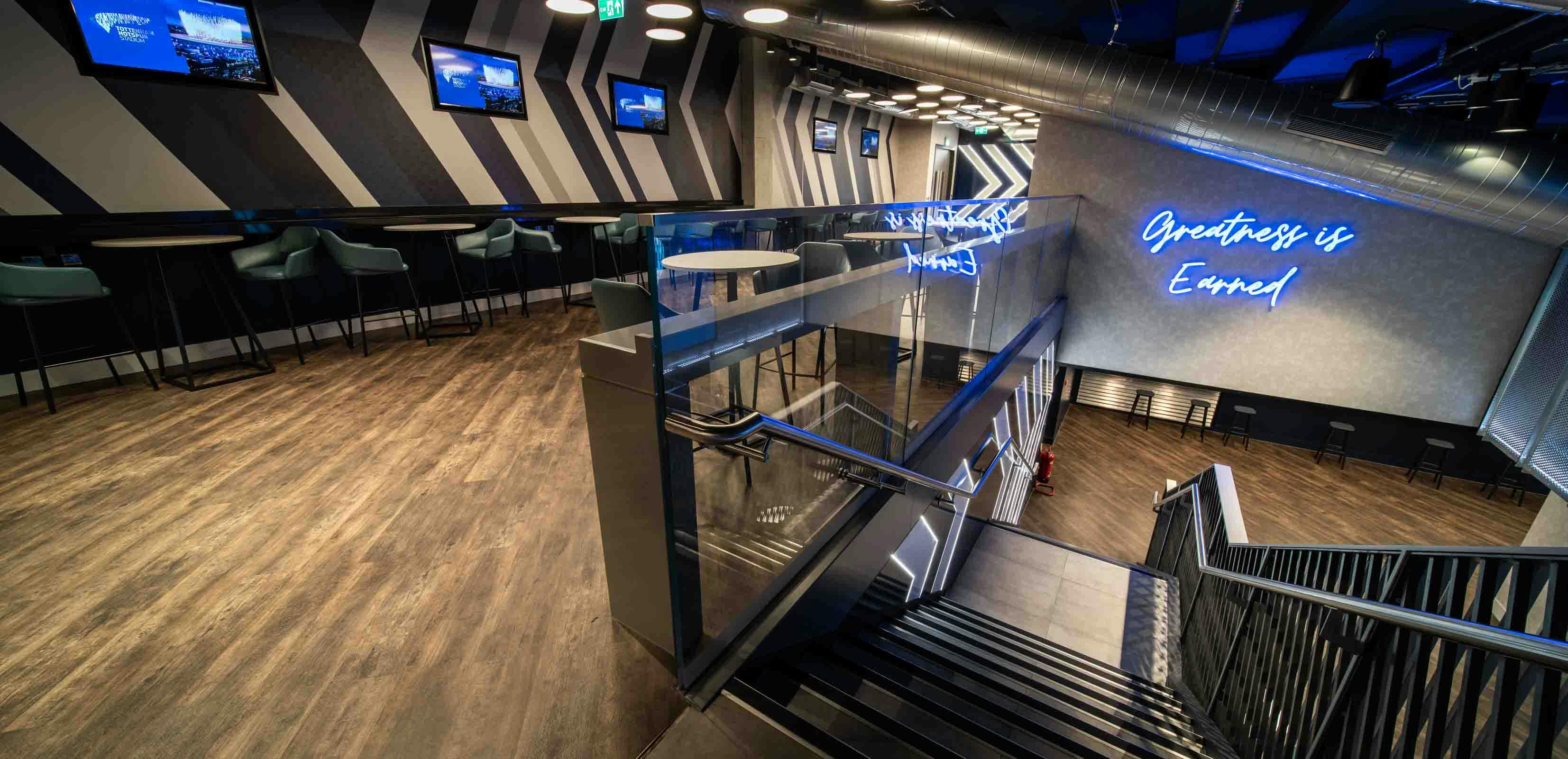 Modern event space in Tottenham Hotspur Stadium with stylish staircase, ideal for networking.