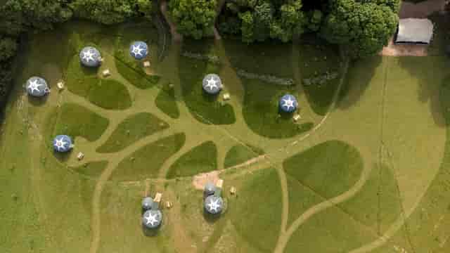 Geodesic domes in lush greenery at Wild Meadow, perfect for outdoor events and workshops.