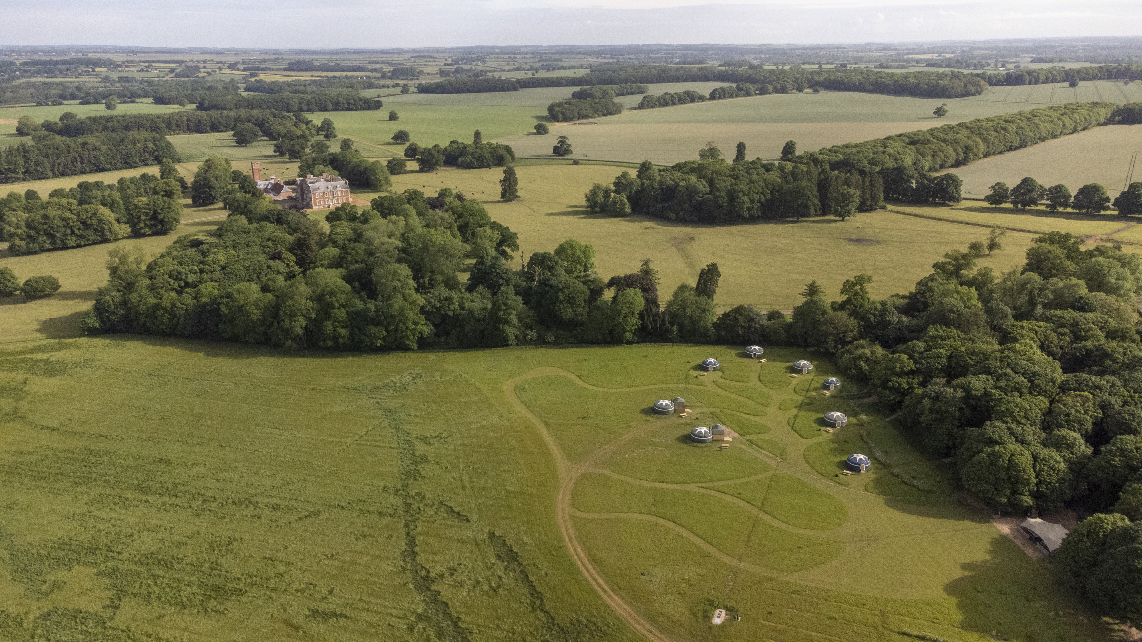 Wild Meadow venue in Raynham with green fields, ideal for retreats and team-building events. - Banner