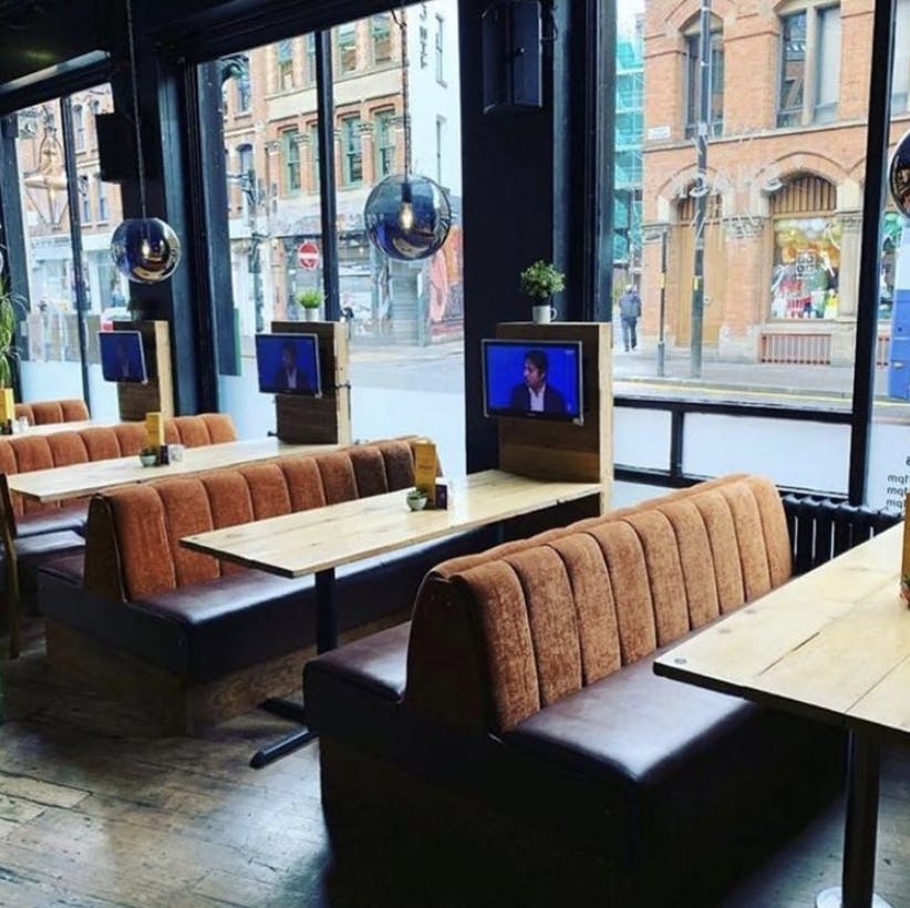 Modern Main Bar at The Shack NQ with wooden tables, ideal for hybrid meetings and events.