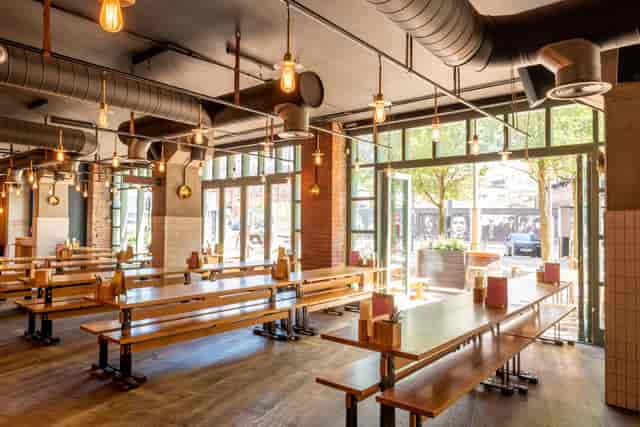 Spacious Birmingham venue with communal tables, ideal for networking events and gatherings.