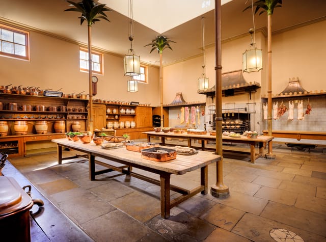 Great Kitchen in Royal Pavilion, rustic wooden tables, ideal for cooking classes and gourmet events.