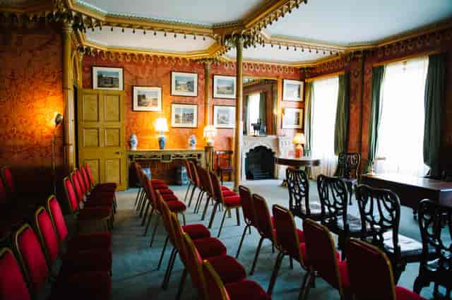 Red Drawing Room in Royal Pavilion, elegant decor for meetings and events.