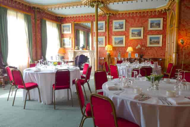 Red Drawing Room at Royal Pavilion, elegant dining setup for formal events and receptions.