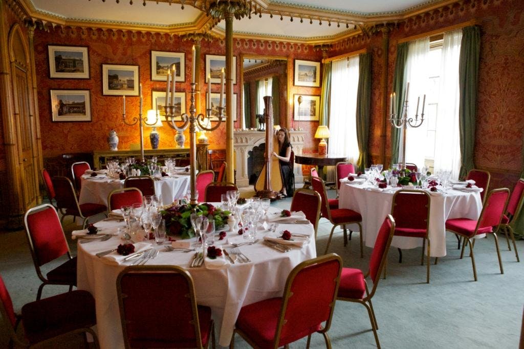 Red Drawing Room at Royal Pavilion, elegant dining setup for upscale events and receptions.