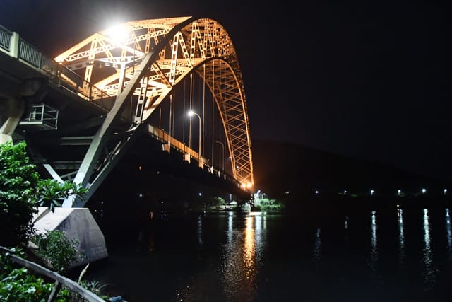 Adomi Bridge at night, illuminated for elegant outdoor events and receptions.