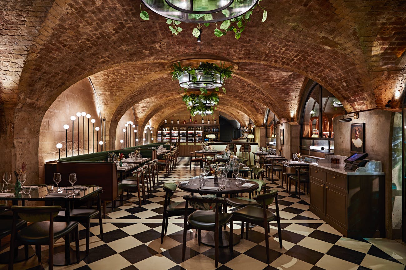 Elegant restaurant with arched ceiling, perfect for upscale events and gatherings.