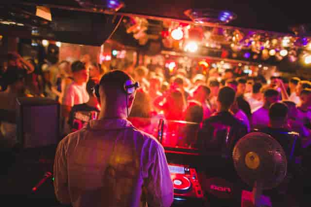 DJ at Pryzm Brighton, vibrant nightlife event with colorful lighting and packed dance floor.