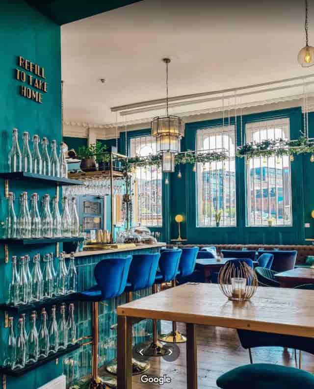 Stylish KILO ZIRO venue with teal decor, ideal for intimate gatherings and meetings.