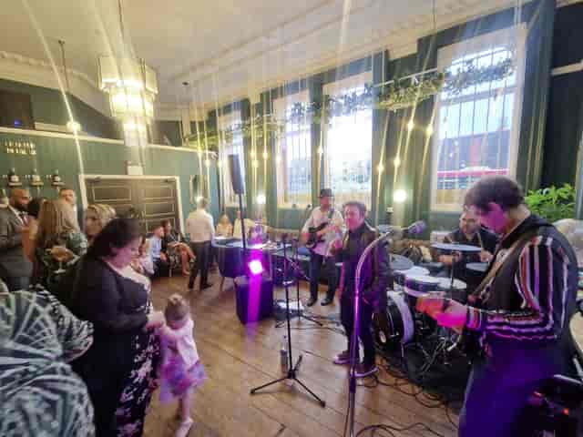 Vibrant KILO ZIRO venue with guests enjoying live music at a networking event.