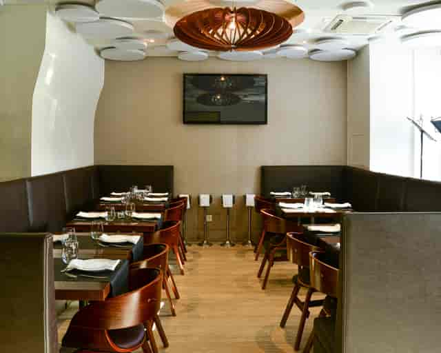 Modern dining space with cozy booths for intimate meetings and small events.