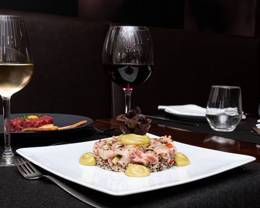 Elegant plated dish with wine for upscale corporate events and private gatherings.
