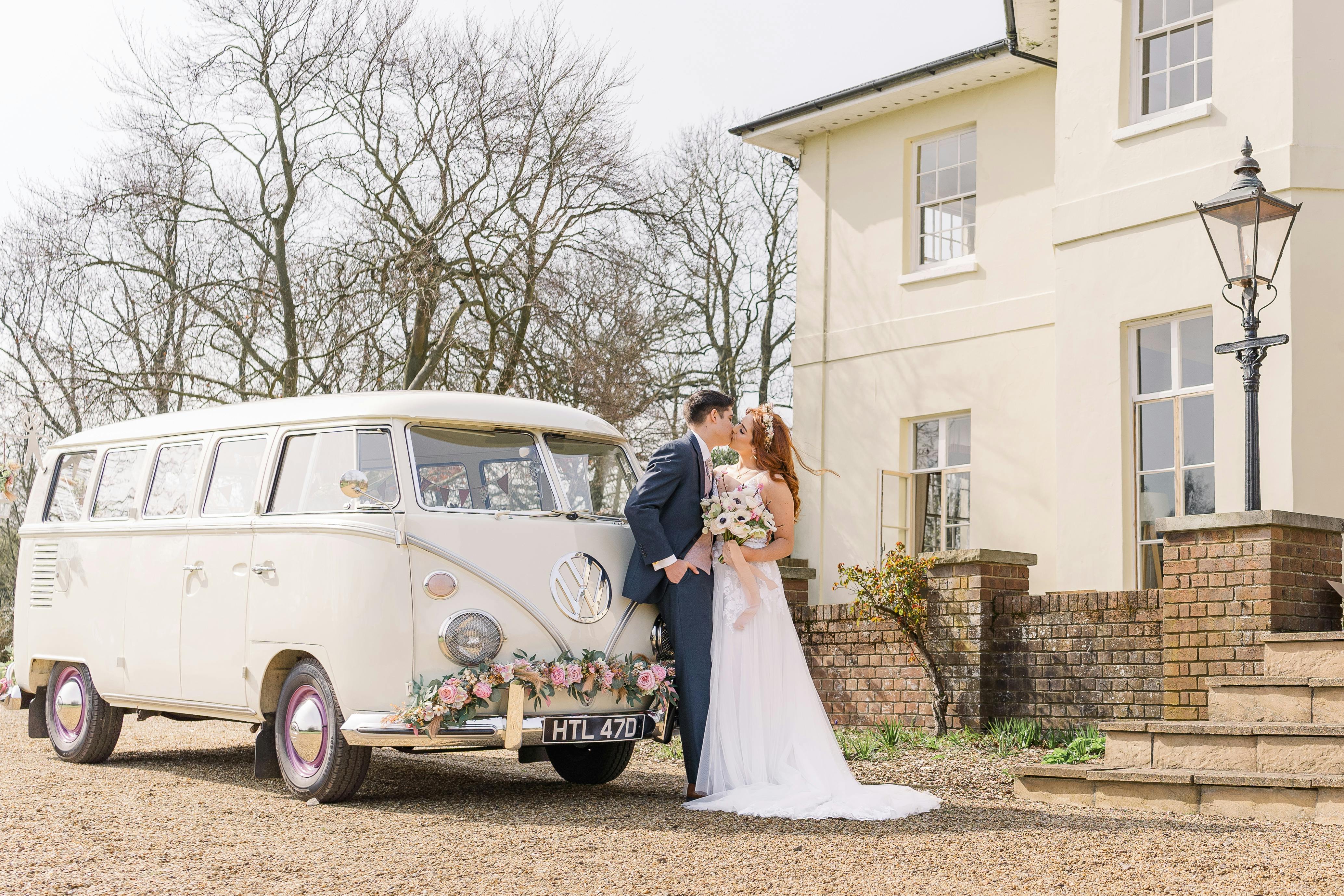 Charming outdoor wedding at Toddington Park with vintage Volkswagen van and floral accents.