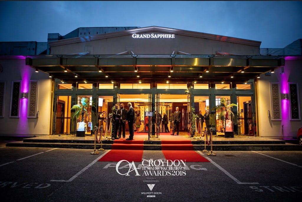 Grand Sapphire Hotel ballroom with red carpet, ideal for award ceremonies and celebrations.